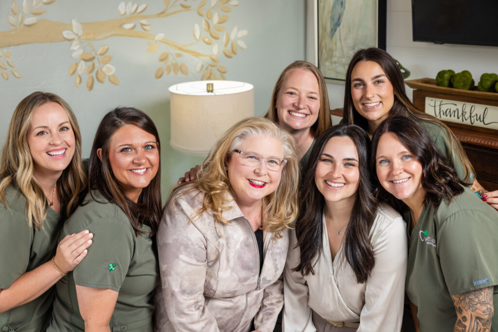 The Ireland Restorative Dentistry team smiling together in a warm, welcoming group portrait